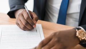 Professional reviewing paperwork at table