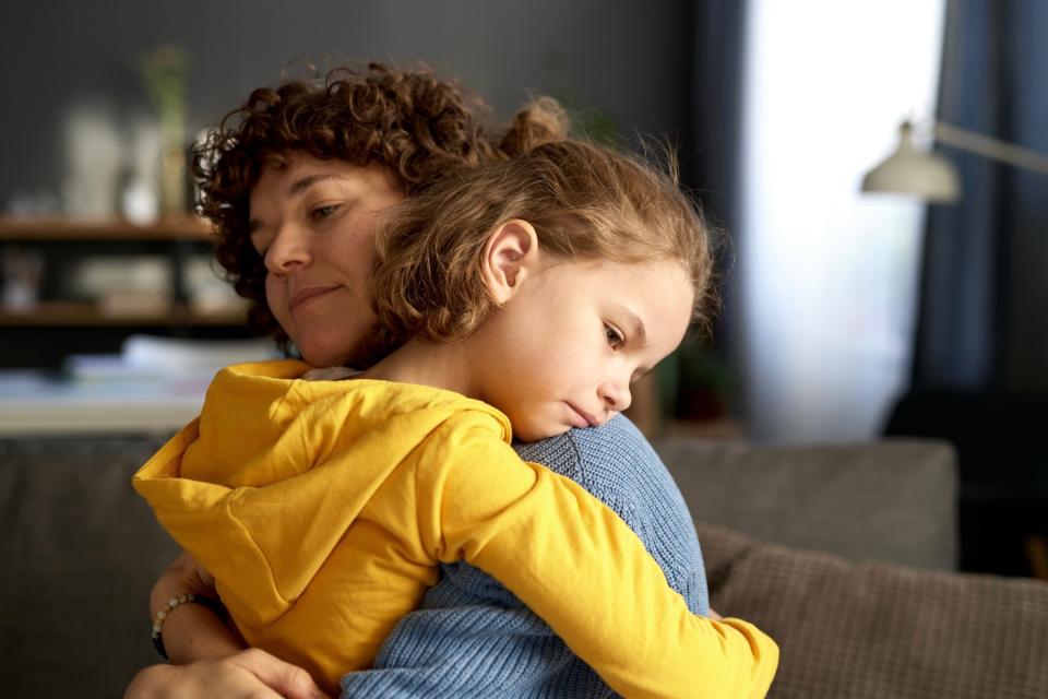 Mom hugging young child. 